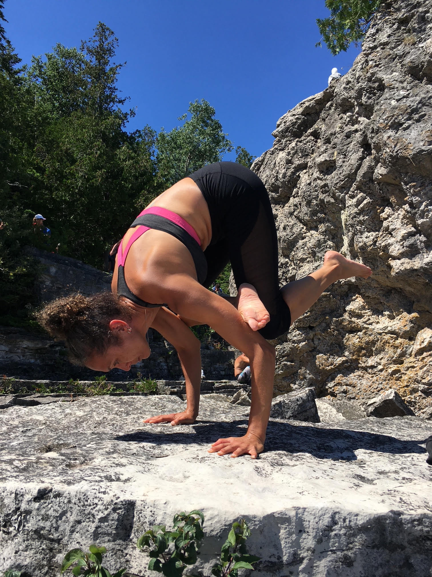 Image of Jodie Rochement in a yoga pose outdoors